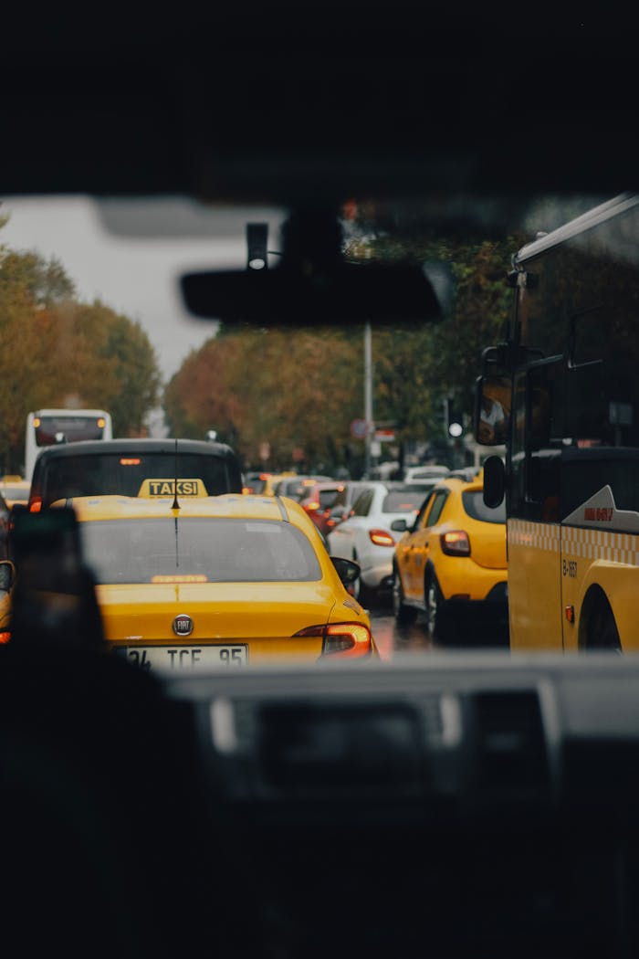 A busy city street with yellow taxis and other vehicles stuck in traffic jam.