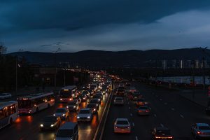 A vibrant scene of night traffic on a city highway, showcasing bustling urban life.